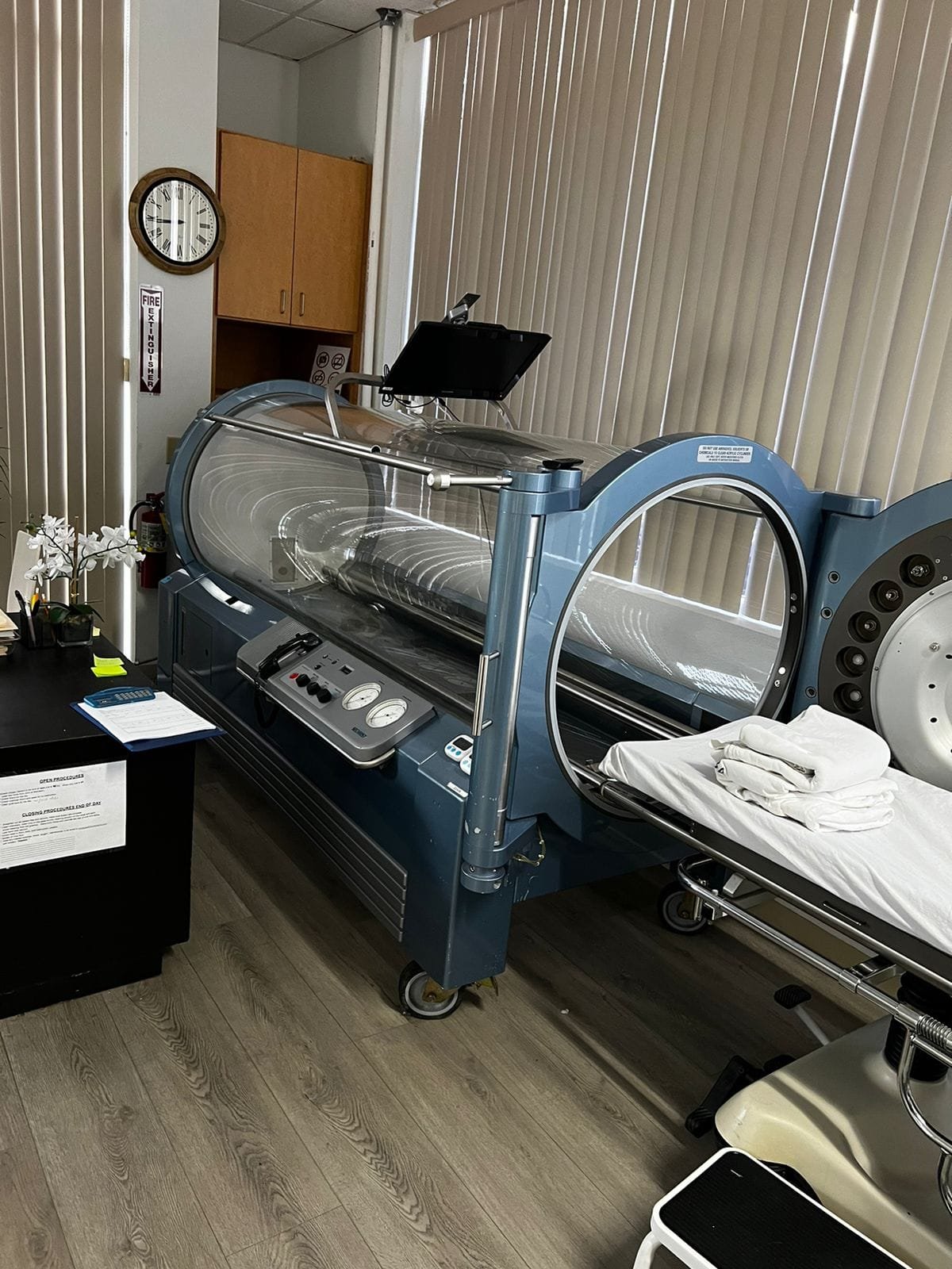 Blue medical-grade hyperbaric chamber in a treatment room at Pacific Hyperbarics — Madras